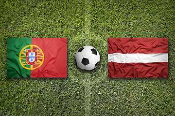Image showing Portugal vs. Latvia flags on soccer field