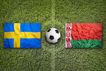 Image showing Sweden vs. Belarus flags on soccer field