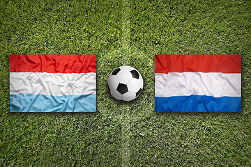 Image showing Luxembourg vs. Netherlands flags on soccer field