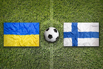 Image showing Ukraine vs. Finland flags on soccer field