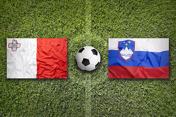 Image showing Malta vs. Slovenia flags on soccer field