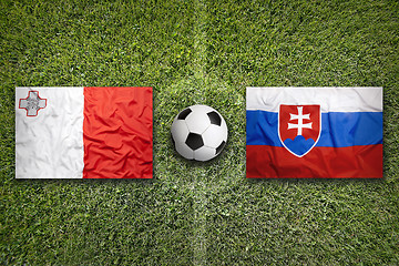 Image showing Malta vs. Slovakia flags on soccer field