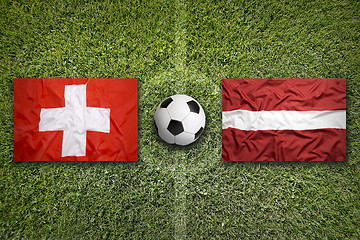 Image showing Switzerland vs. Latvia flags on soccer field