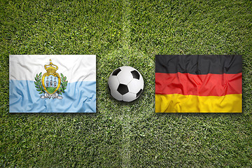 Image showing San Marino vs. Germany flags on soccer field