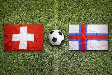 Image showing Switzerland vs. Faroe islands flags on soccer field