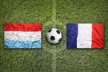 Image showing Luxembourg vs. France flags on soccer field