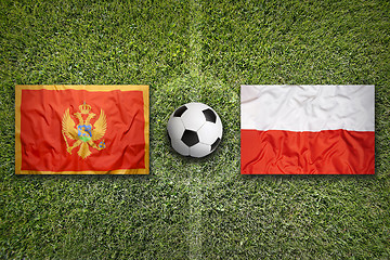 Image showing Montenegro vs. Poland flags on soccer field