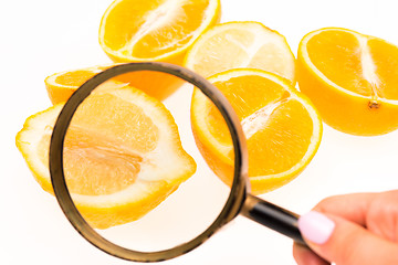 Image showing Lemon and a magnifying glass on white background