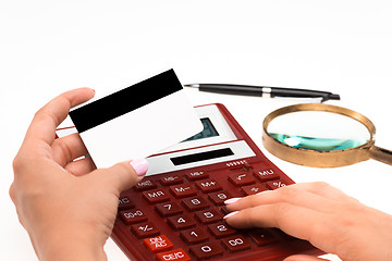 Image showing Concept for Internet shopping: hands with calculator and credit card