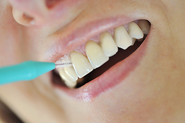 Image showing A Woman Cleaning Her Teeth