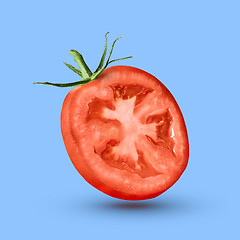 Image showing half tomato over a blue background