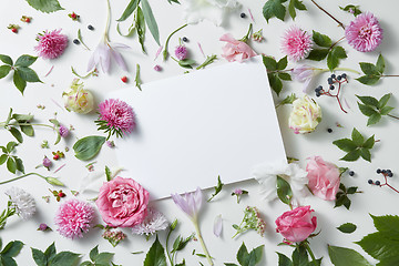 Image showing flowers with empty white notebook