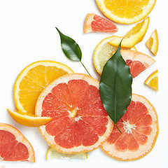 Image showing Fresh citrus fruits slices background viewed from above.