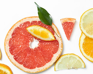 Image showing Fresh citrus fruits slices background viewed from above.