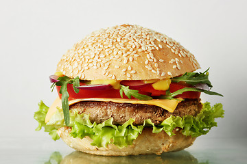 Image showing Fresh burger with beef, cheese and tomatoes.