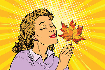 Image showing Girl and autumn, a woman with red maple leaf