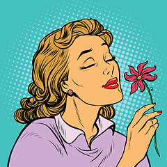 Image showing Beautiful woman inhaling fragrance of a flower