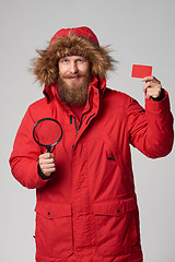 Image showing Man wearing red winter Alaska jacket with fur hood on