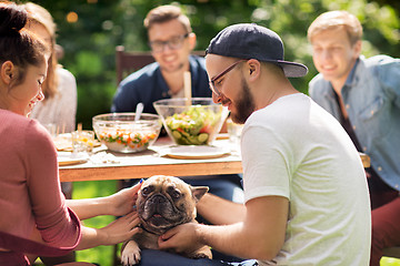 Image showing happy friends having dinner at summer garden party