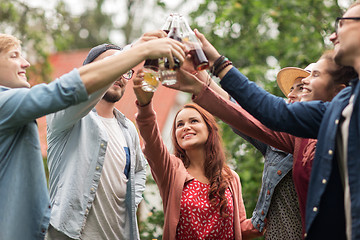 Image showing happy friends clinking glasses at summer garden