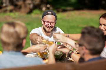 Image showing happy friends having dinner at summer garden party