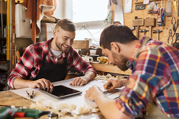 Image showing workmen with tablet pc and blueprint at workshop