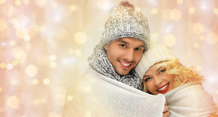 Image showing happy family couple in winter clothes hugging