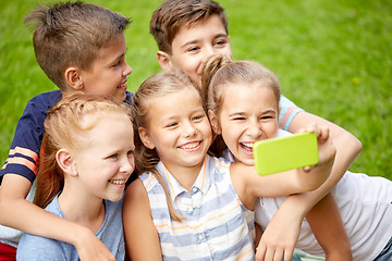 Image showing happy kids or friends taking selfie in summer park
