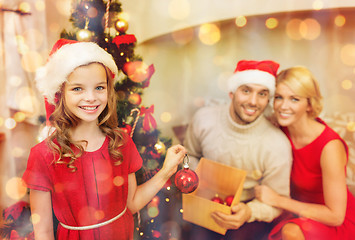 Image showing smiling family decorating christmas tree