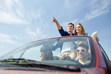 Image showing happy friends driving in cabriolet car