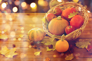 Image showing close up of pumpkins in basket on wooden table
