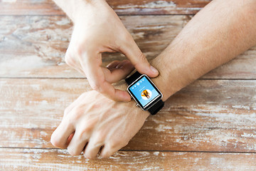 Image showing close up of hands with music player on smart watch