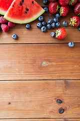 Image showing close up of fruits and berries on wooden table