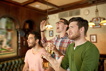 Image showing friends with beer watching sport at bar or pub