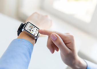 Image showing close up of hands with online shop on smart watch