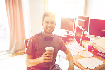 Image showing happy creative male office worker drinking coffee