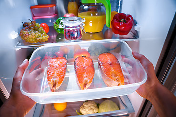 Image showing Raw Salmon steak in the open refrigerator