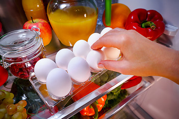 Image showing Chicken eggs on a shelf open refrigerator