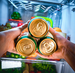 Image showing Man taking beer from a fridge