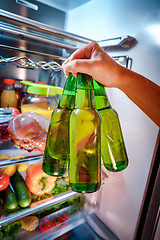 Image showing Man taking beer from a fridge