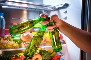 Image showing Man taking beer from a fridge