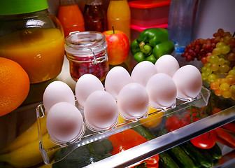 Image showing Chicken eggs on a shelf open refrigerator