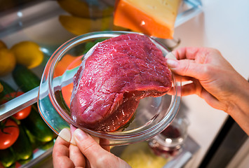 Image showing Fresh raw meat on a shelf open refrigerator