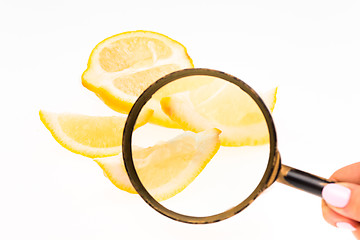 Image showing Lemon and a magnifying glass on white background