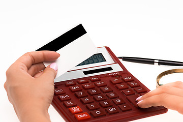 Image showing Concept for Internet shopping: hands with calculator and credit card