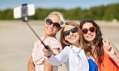 Image showing group of smiling women taking selfie on beach