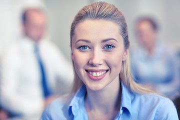 Image showing group of smiling businesspeople meeting in office