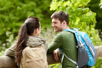 Image showing smiling couple with backpacks in nature