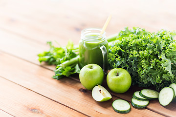 Image showing close up of jug with green juice and vegetables