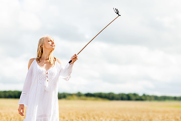 Image showing happy young woman taking selfie by smartphone